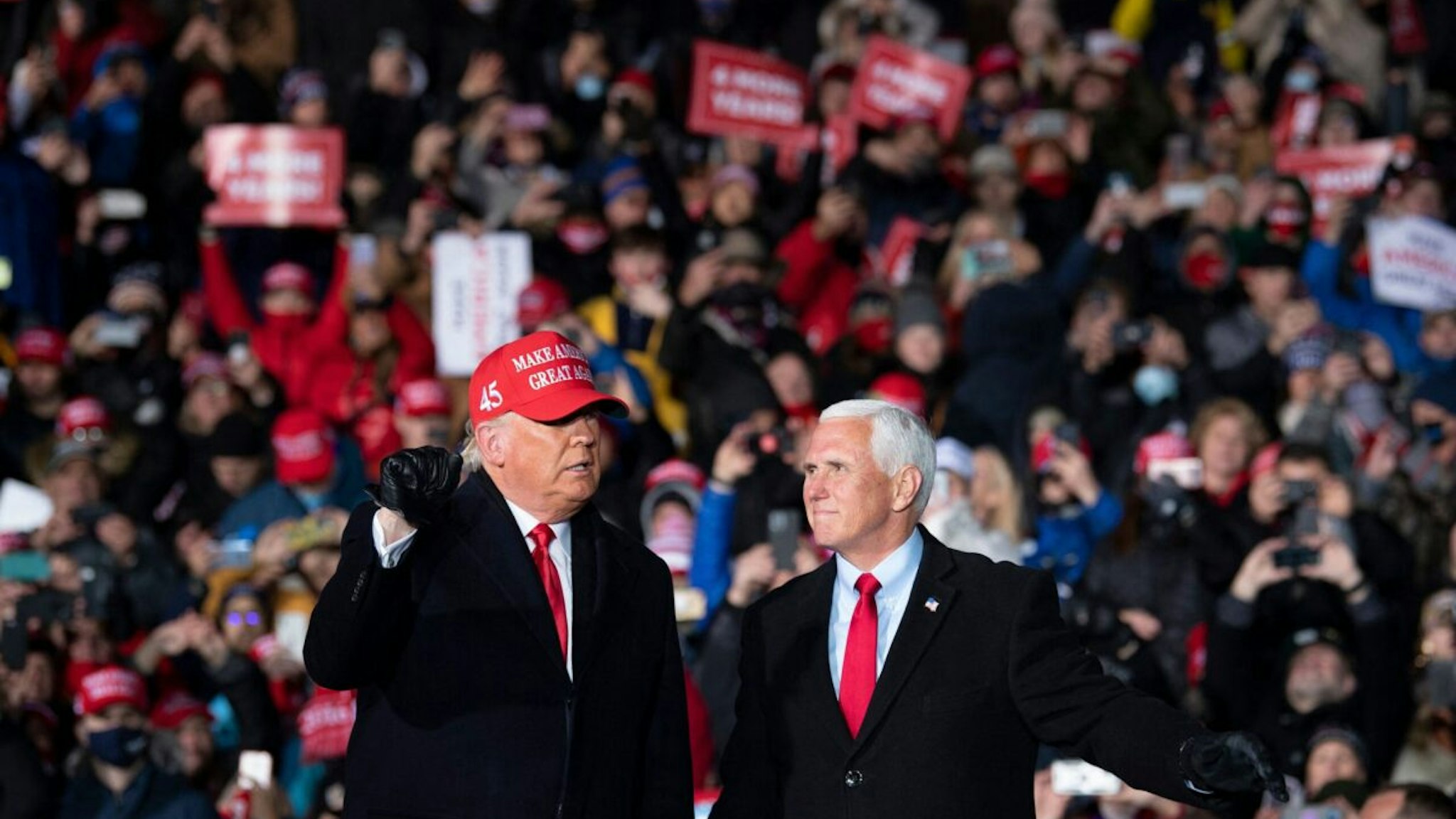 US President Donald Trump arrives with US Vice President Mike Pence for a Make America Great Again rally at Cherry Capital Airport in Traverse City, Michigan on November 2, 2020.