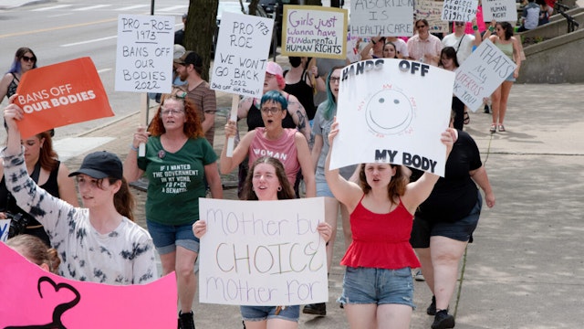 DAYTON, OHIO, UNITED STATES - 2022/05/14: Protesters hold placards expressing their opinion at a pro abortion rights rally. People from many different cities gathered to support and rally for abortion rights. In light of the Supreme Court decision that could overturn Roe v. Wade that leaked roughly two weeks ago, hundreds of people in Dayton, spoke and marched for abortion access.