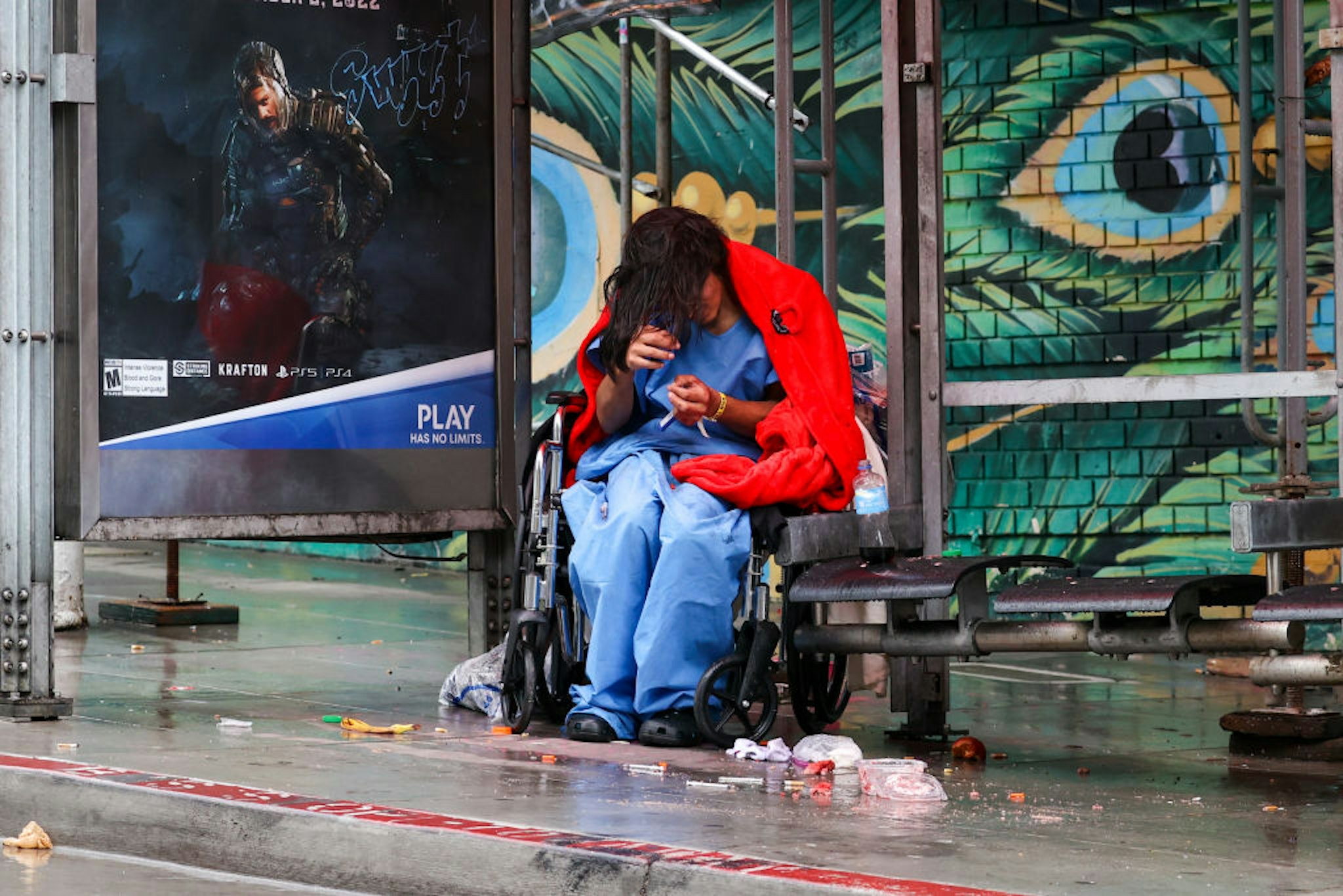 SAN FRANCISCO, CA - JANUARY 13: A homeless woman with wheelchair is seen on a bus stop near the City Hall during rainy day in San Francisco on January 13, 2023 as atmospheric river storms hit California, United States. (Photo by Tayfun Coskun/Anadolu Agency via Getty Images)