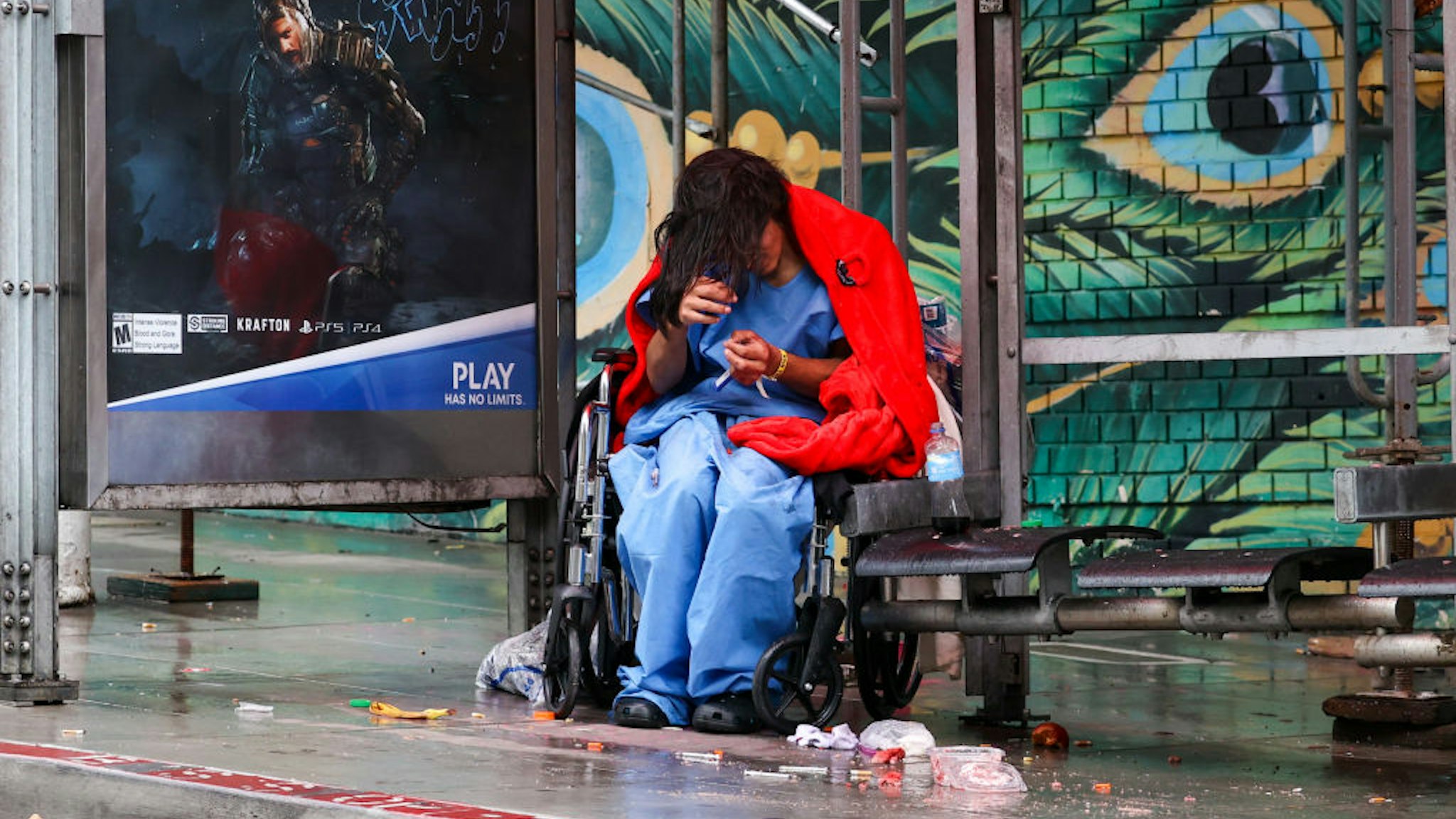 SAN FRANCISCO, CA - JANUARY 13: A homeless woman with wheelchair is seen on a bus stop near the City Hall during rainy day in San Francisco on January 13, 2023 as atmospheric river storms hit California, United States. (Photo by Tayfun Coskun/Anadolu Agency via Getty Images)