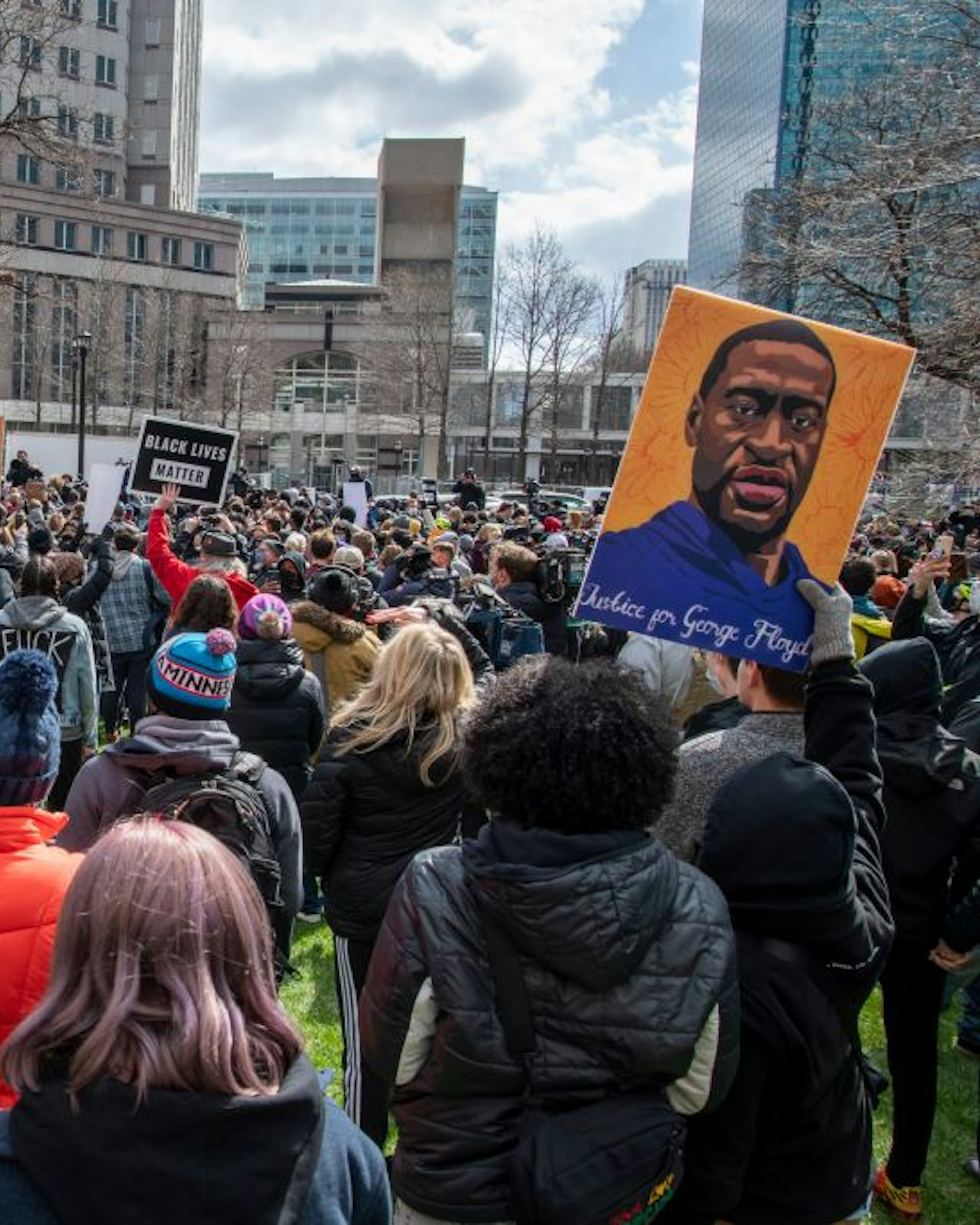 Minneapolis, Minnesota. Protesters hold up signs in front of the government center while waiting for the verdict in the trial of Derek Chauvin for the killing of George Floyd. (Photo by: Michael Siluk/Education Images/Universal Images Group via Getty Images)