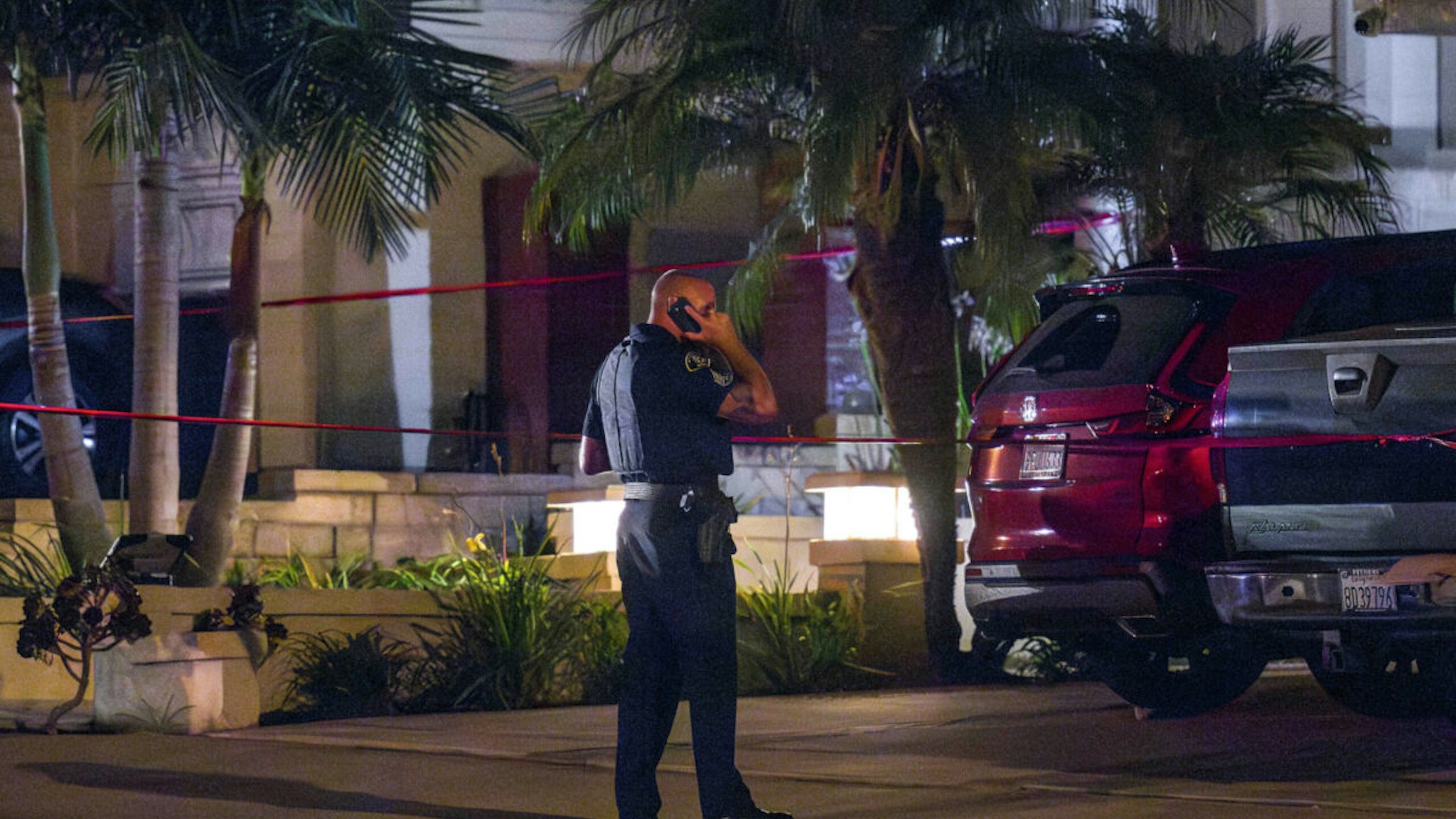 ANAHEIM, CA - AUGUST 03: An Anaheim Police officer stands outside a home, right, in the 8500 block of E. Canyon Vista Drive in Anaheim on Thursday, August 3, 2023 where Orange County Superior Court Judge Jeffrey Ferguson was taken into custody by Anaheim police after a shooting death of his wife, according to multiple sources.