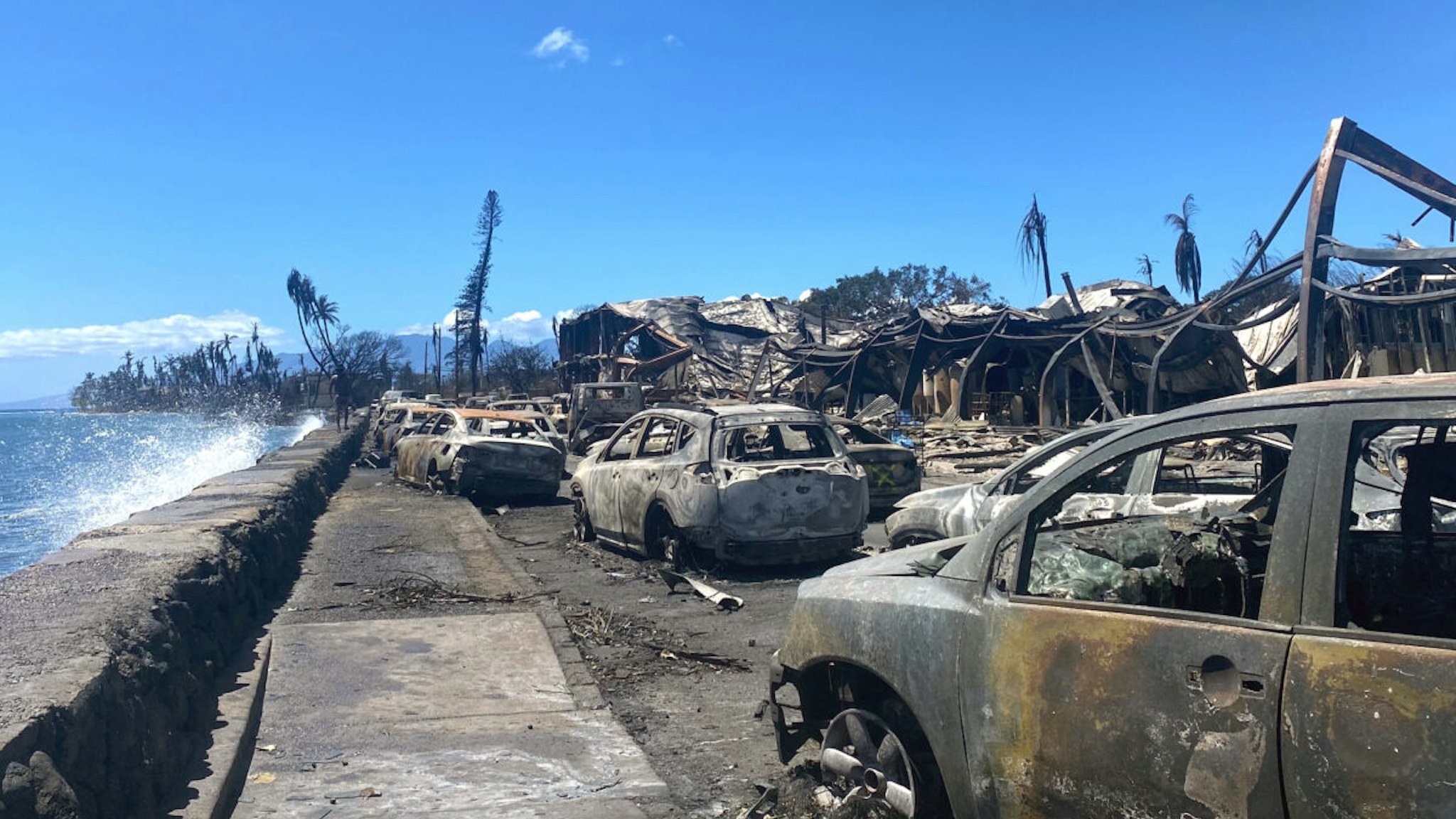 Burned cars and destroyed buildings are pictured in the aftermath of a wildfire in Lahaina, western Maui, Hawaii on August 11, 2023. A wildfire that left Lahaina in charred ruins has killed at least 55 people, authorities said on August 10, making it one of the deadliest disasters in the US state's history. Brushfires on Maui, fueled by high winds from Hurricane Dora passing to the south of Hawaii, broke out August 8 and rapidly engulfed Lahaina. (Photo by Paula RAMON / AFP) / "The erroneous mention[s] appearing in the metadata of this photo by Paula RAMON has been modified in AFP systems in the following manner: [August 11] instead of [August 10]. Please immediately remove the erroneous mention[s] from all your online services and delete it (them) from your servers. If you have been authorized by AFP to distribute it (them) to third parties, please ensure that the same actions are carried out by them. Failure to promptly comply with these instructions will entail liability on your part for any continued or post notification usage. Therefore we thank you very much for all your attention and prompt action. We are sorry for the inconvenience this notification may cause and remain at your disposal for any further information you may require."
