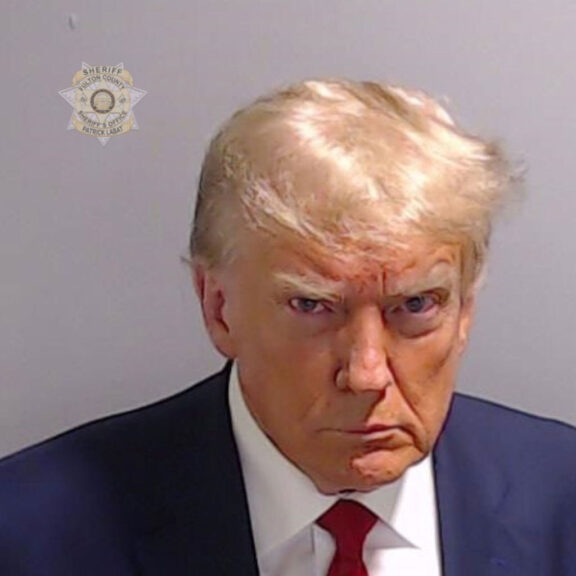 ATLANTA, GEORGIA, USA - AUGUST 24: (----EDITORIAL USE ONLY - MANDATORY CREDIT - 'FULTON COUNTY SHERIFF'S OFFICE / HANDOUT' - NO MARKETING NO ADVERTISING CAMPAIGNS - DISTRIBUTED AS A SERVICE TO CLIENTS----) Former U.S. President Donald Trump poses for his booking photo at the Fulton County Jail on August 24, 2023 in Atlanta, Georgia, United States. Trump was booked on 13 charges related to an alleged plan to overturn the results of the 2020 presidential election in Georgia. Trump and 18 others facing felony charges have been ordered to turn themselves in to the Fulton County Jail by August 25. (Photo by Fulton County Sheriff's Office / Handout/Anadolu Agency via Getty Images)