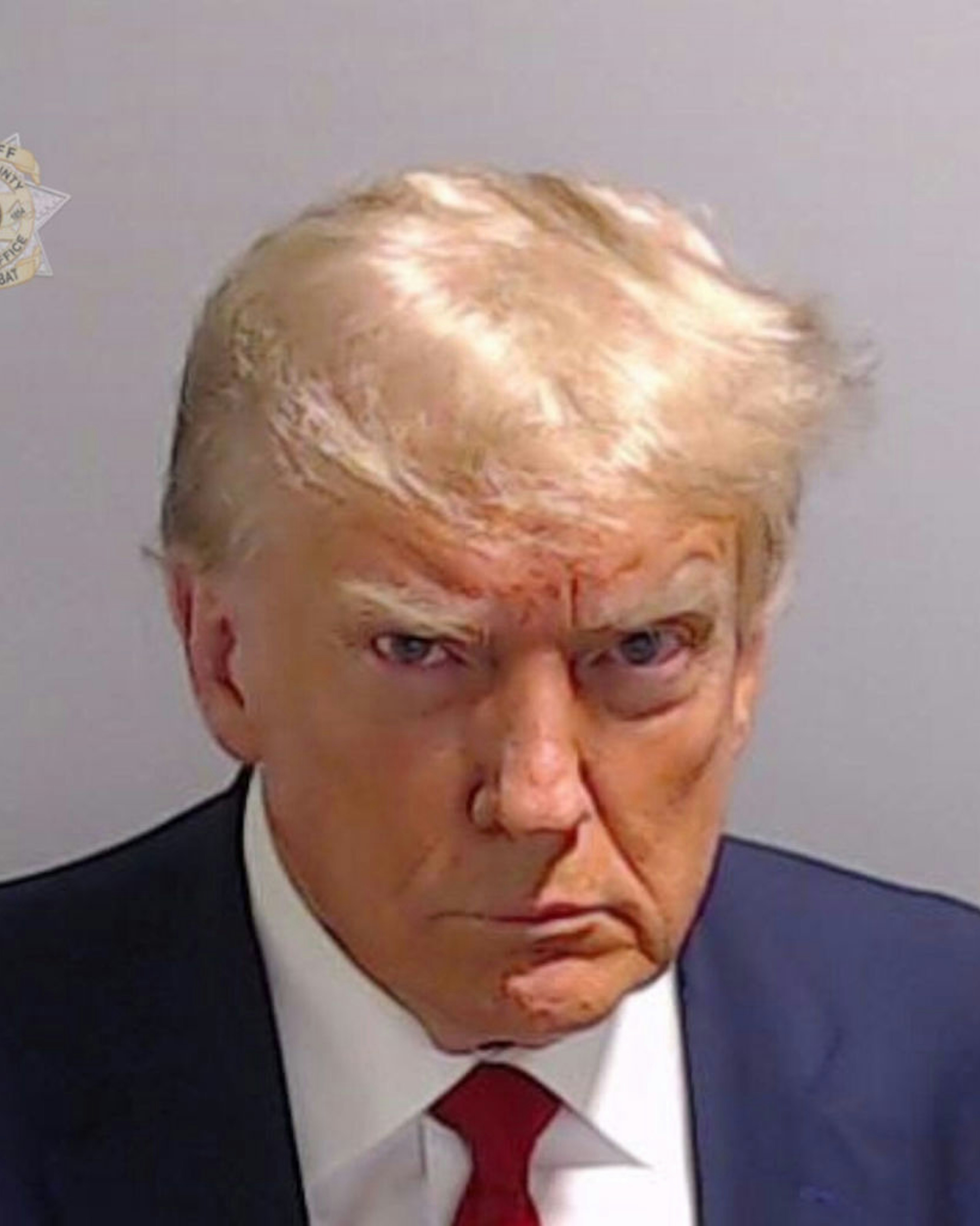 ATLANTA, GEORGIA, USA - AUGUST 24: (----EDITORIAL USE ONLY - MANDATORY CREDIT - 'FULTON COUNTY SHERIFF'S OFFICE / HANDOUT' - NO MARKETING NO ADVERTISING CAMPAIGNS - DISTRIBUTED AS A SERVICE TO CLIENTS----) Former U.S. President Donald Trump poses for his booking photo at the Fulton County Jail on August 24, 2023 in Atlanta, Georgia, United States. Trump was booked on 13 charges related to an alleged plan to overturn the results of the 2020 presidential election in Georgia. Trump and 18 others facing felony charges have been ordered to turn themselves in to the Fulton County Jail by August 25. (Photo by Fulton County Sheriff's Office / Handout/Anadolu Agency via Getty Images)