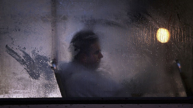 GLASGOW, UNITED KINGDOM - OCTOBER 10: A man makes his way home from work on a bus as darkness falls on October 10, 2005 in Glasgow, Scotland. Seasonal affective disorder (SAD), or winter depression, is a mood disorder related to the change in the seasons and the resulting reduction of exposure to daylight. The end of British Summer time, when clocks go back one hour at the end of October, will see most people making their daily commute in darkness both ways. With winter nights stretching to 19 hours in the UK, and Scotland's often inclement weather, it is estimated that the "Winter Blues" can affect up to 20% of the population. (Photo by Christopher Furlong/Getty Images)