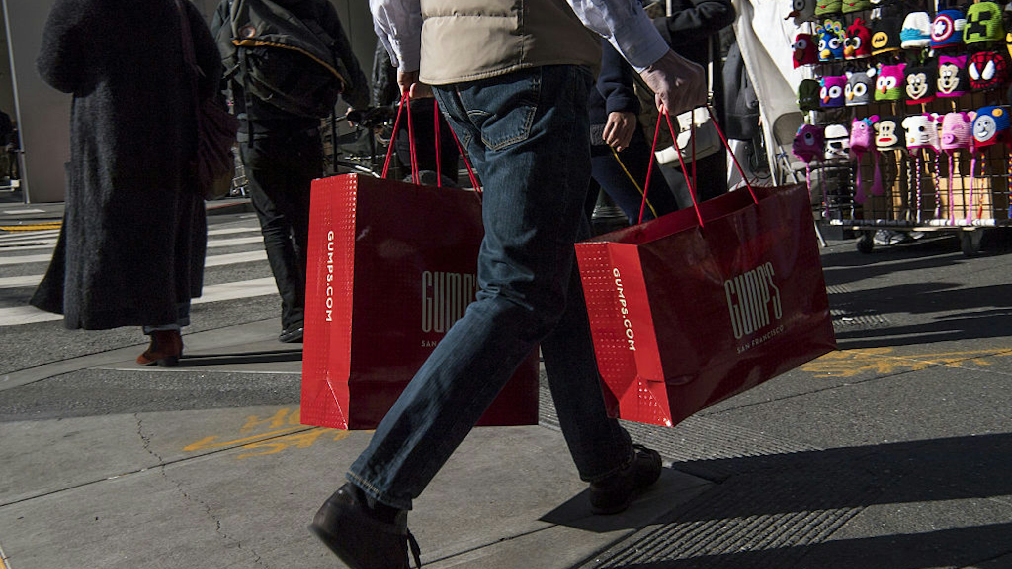 A shopper carries Gump's Corp. shopping bags in San Francisco, California, U.S., on Monday, Dec. 26, 2016. The Bloomberg Consumer Comfort Index, a survey which measures attitudes about the economy, is scheduled to be released on December 29. Photographer: David Paul Morris/Bloomberg via Getty Images