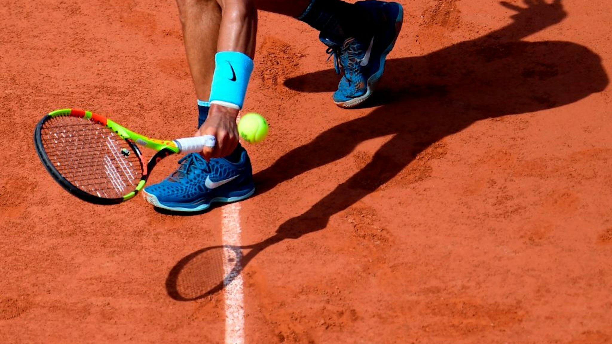 Spain's Rafael Nadal casts a shadow on court as he plays a backhand return to Argentina's Juan Martin del Potro during their men's singles semi-final match on day thirteen of The Roland Garros 2018 French Open tennis tournament in Paris on June 8, 2018. (Photo by CHRISTOPHE SIMON / AFP) (Photo credit should read CHRISTOPHE SIMON/AFP via Getty Images)