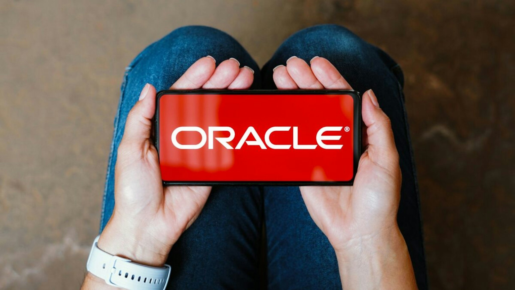 In this photo illustration, the Oracle Corporation logo is displayed on a smartphone screen.