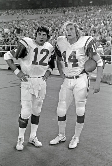 PITTSBURGH, PA - SEPTEMBER 4: (EDITORS NOTE: Image has been shot in black and white. Color version not available.) Quarterbacks Joe Namath #12 and Richard Todd #14 of the New York Jets look on from the sideline during a preseason game against the Pittsburgh Steelers at Three Rivers Stadium on September 4, 1976 in Pittsburgh, Pennsylvania. The Steelers defeated the Jets 41-6. (Photo by George Gojkovich/Getty Images)