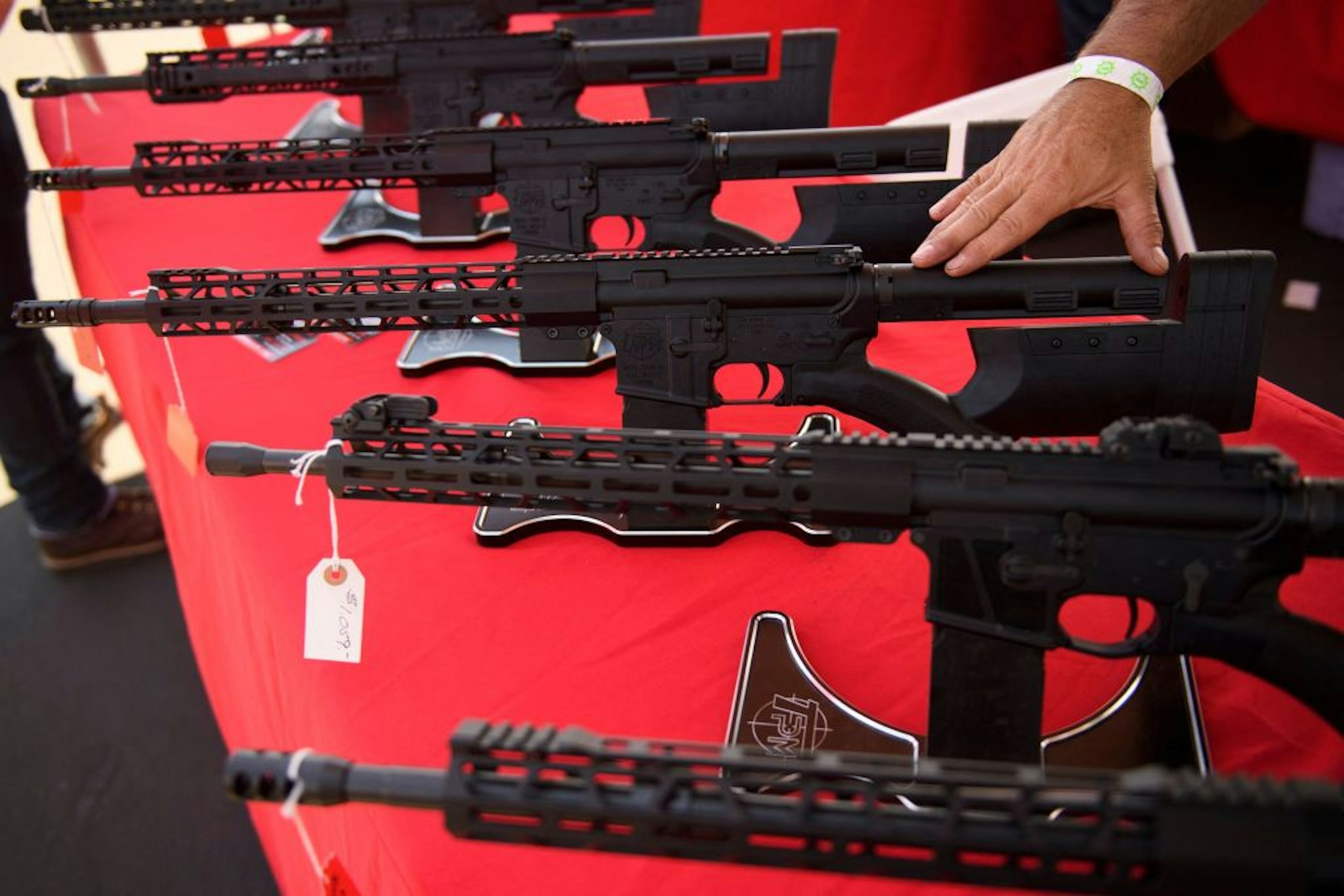 A TPM Arms LLC California-legal featureless AR-15 style rifle is displayed for sale at the company's booth at the Crossroads of the West Gun Show at the Orange County Fairgrounds on June 5, 2021 in Costa Mesa, California. - Gun sales increased in the US following Covid-19 pandemic lockdowns. On June 4, a San Diego federal court judge overturned California's three-decade old ban on assault weapons, defined as a semiautomatic rifle or pistol with a detachable magazine and certain features, but granted a 30-day stay for a State appeal and likely future court decisions on the constitutionality of the ban under the Second Amendment. An industry of California legal "featureless" or "compliant" AR-15 style rifles developed for California consumers, adapting to the law with design changes to the popular rifle. (Photo by Patrick T. FALLON / AFP)
