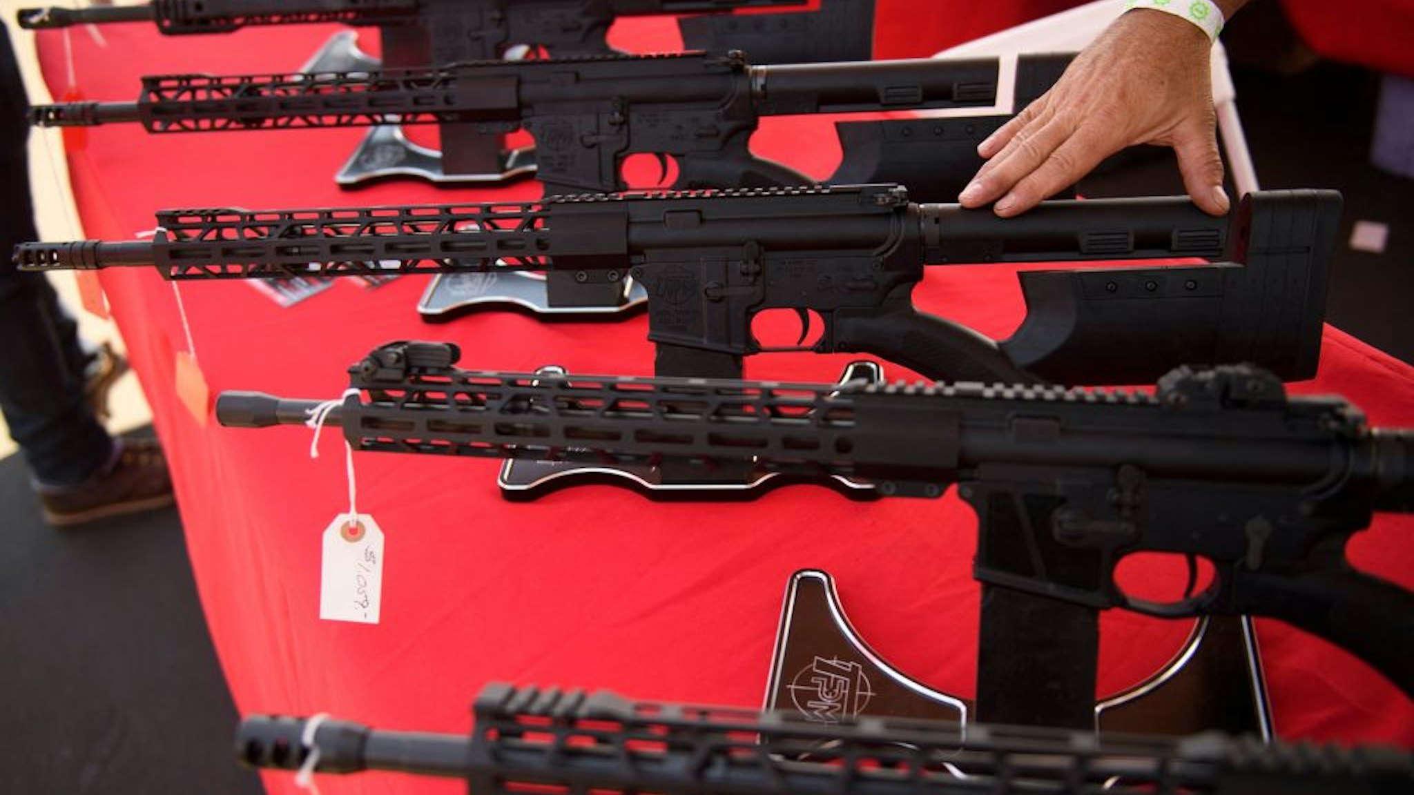 A TPM Arms LLC California-legal featureless AR-15 style rifle is displayed for sale at the company's booth at the Crossroads of the West Gun Show at the Orange County Fairgrounds on June 5, 2021 in Costa Mesa, California. - Gun sales increased in the US following Covid-19 pandemic lockdowns. On June 4, a San Diego federal court judge overturned California's three-decade old ban on assault weapons, defined as a semiautomatic rifle or pistol with a detachable magazine and certain features, but granted a 30-day stay for a State appeal and likely future court decisions on the constitutionality of the ban under the Second Amendment. An industry of California legal "featureless" or "compliant" AR-15 style rifles developed for California consumers, adapting to the law with design changes to the popular rifle. (Photo by Patrick T. FALLON / AFP)