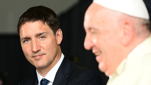 Canadian Prime Minister Justin Trudeau (L) greets Pope Francis during a welcoming ceremony at Edmonton International Airport in Alberta, western Canada, on July 24, 2022. - Pope Francis visits Canada for a chance to personally apologize to Indigenous survivors of abuse committed over a span of decades at residential schools run by the Catholic Church. (Photo by Vincenzo PINTO / AFP) (Photo by VINCENZO PINTO/AFP via Getty Images)