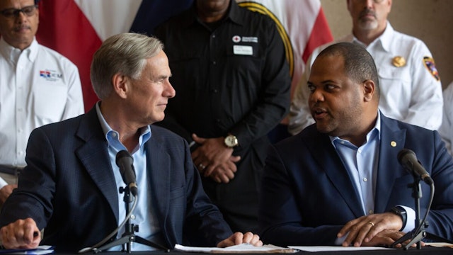 Eric Johnson, mayor of Dallas, right, speaks with Greg Abbott, governor of Texas, during a news conference in Dallas, Texas, US, on Tuesday, Aug. 23, 2022. A massive rainstorm in North Texas drenched parts of the Dallas-Fort Worth area with more than a foot of water, swamping roadways, triggering flash flood warnings and killing at least one person in what experts call a once-in-200-years event.