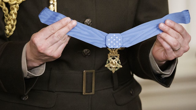 A military aid holds up the Medal of Honor before it is presented to Retired US Army Colonel Paris Davis by US President Joe Biden in the East Room of the White House in Washington, DC, US, on Friday, March 3, 2023. Davis is being presented the honor for his heroism during the Vietnam War.