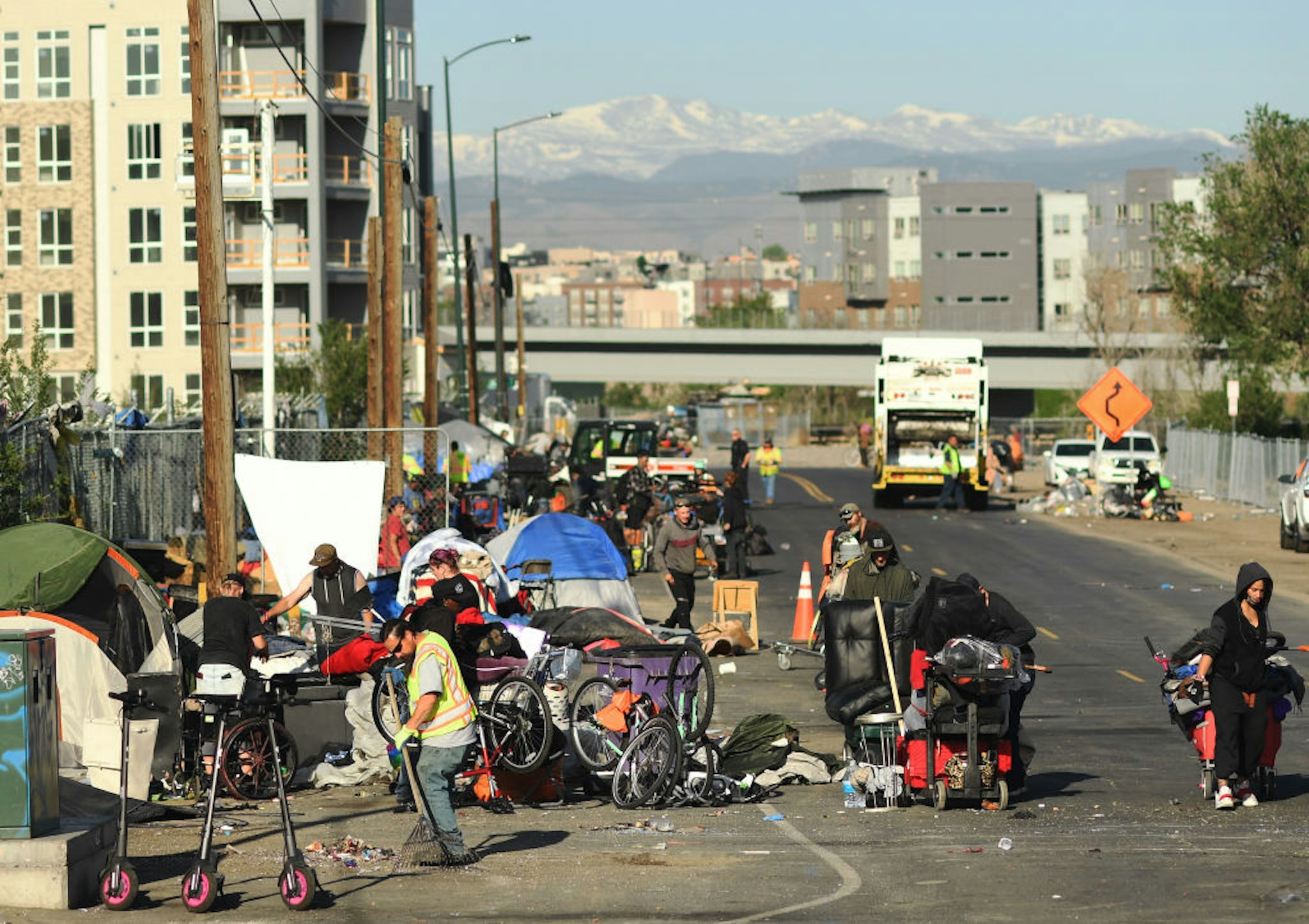 DENVER, COLORADO - MAY 17: People exercising homelessness gather belonging as crews work to cleanup a homeless camp in the RiNo neighborhood near the Platte River on May 17, 2022 in Denver, Colorado.(Photo by RJ Sangosti/MediaNews Group/The Denver Post via Getty Images)"n"n