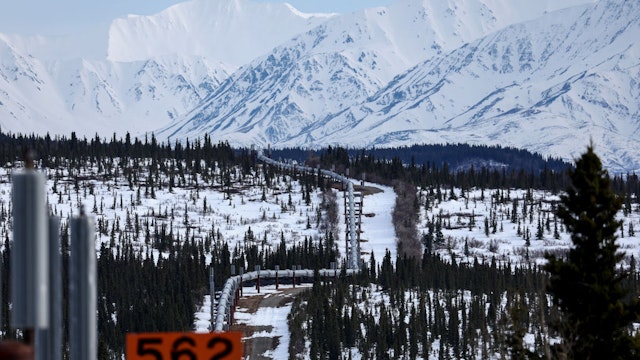 DELTA JUNCTION, ALASKA - MAY 05: A part of the Trans Alaska Pipeline System runs through boreal forest past Alaska Range mountains on May 5, 2023 near Delta Junction, Alaska. The 800-mile-long pipeline carries oil from the North Slope in Prudhoe Bay to the port of Valdez. In March, the Biden administration approved the controversial Willow project which will extract 600 million barrels of oil from the National Petroleum Reserve on Alaska’s North Slope, close to the Arctic Ocean.