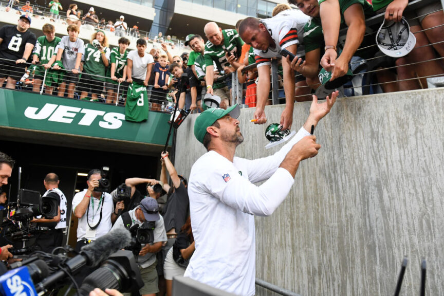 CANTON, OHIO - AUGUST 03: Aaron Rodgers #8 of the New York Jets signs autographs prior to the 2023 Pro Hall of Fame Game against the Cleveland Browns at Tom Benson Hall Of Fame Stadium on August 3, 2023 in Canton, Ohio. (Photo by Nick Cammett/Getty Images)