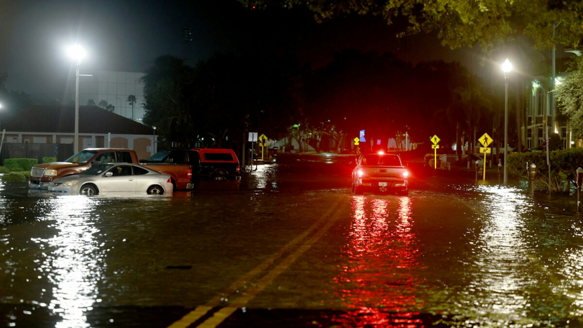 A vehicle drives through flood waters caused by Hurricane Idalia passing offshore on August 30, 2023 in St. Petersburg, Florida. Hurricane Idalia is hitting the Big Bend area of Florida.
