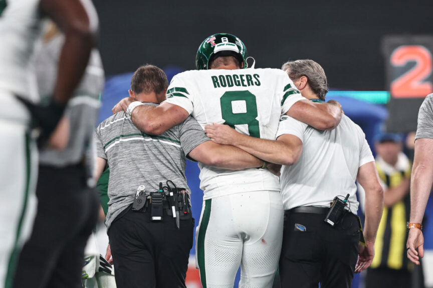 EAST RUTHERFORD, NEW JERSEY - SEPTEMBER 11: Aaron Rodgers #8 of the New York Jets is helped off the field after suffering an apparent injury after being sacked by Leonard Floyd #56 of the Buffalo Bills during a game at MetLife Stadium on September 11, 2023 in East Rutherford, New Jersey. (Photo by Michael Owens/Getty Images)