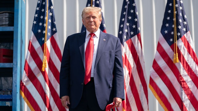 SUMMERVILLE, SOUTH CAROLINA - SEPTEMBER 25: Former President Donald Trump stands in front of American flags during a campaign rally on September 25, 2023 in Summerville, South Carolina. The former president has a strong lead in the polls over his Republican challengers and does not plan to participate in Wednesday's Republican presidential debate.