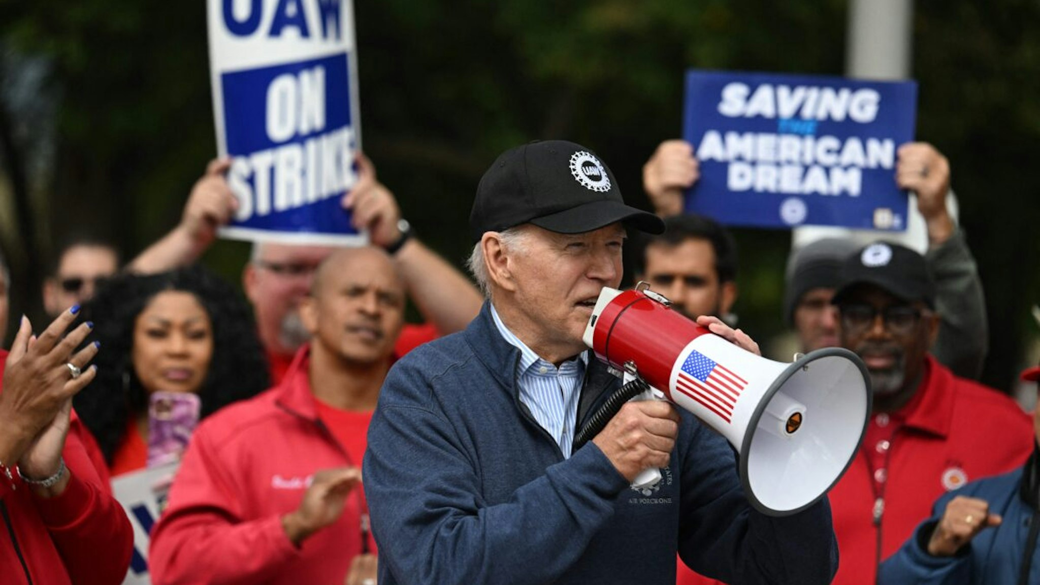 US President Joe Biden addresses striking members of the United Auto Workers (UAW) union at a picket line outside a General Motors Service Parts Operations plant in Belleville, Michigan, on September 26, 2023.