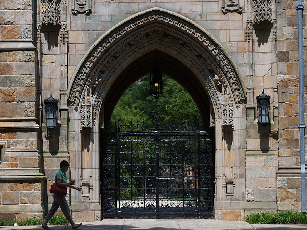 A pedestrian walks past Harkness Gate on the Yale University campus in New Haven, Connecticut, U.S., on Friday, June 12, 2015. Yale University is an educational institute that offers undergraduate degree programs in art, law, engineering, medicine, and nursing as well as graduate level programs. Photographer: Craig Warga/Bloomberg via Getty Images