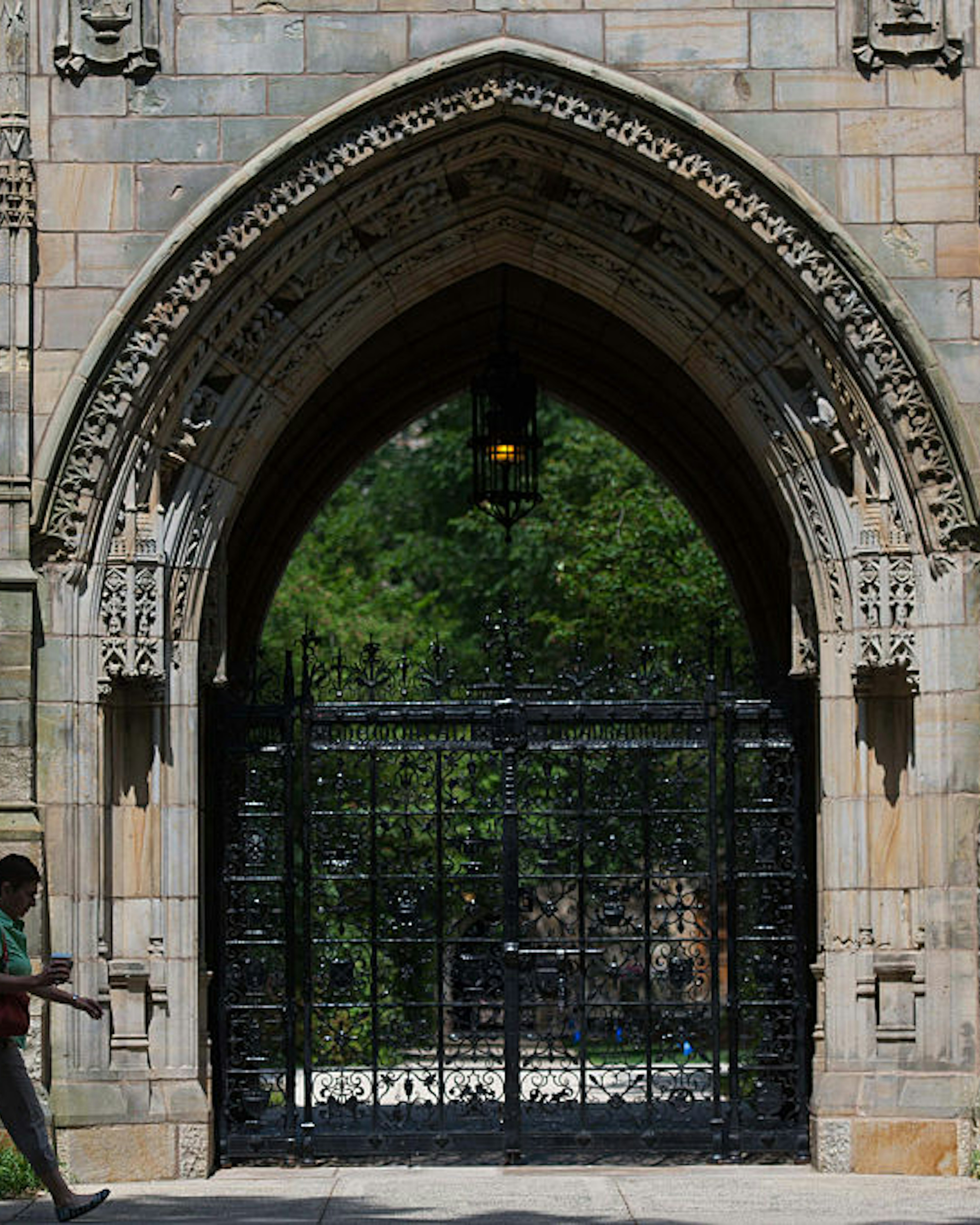 A pedestrian walks past Harkness Gate on the Yale University campus in New Haven, Connecticut, U.S., on Friday, June 12, 2015. Yale University is an educational institute that offers undergraduate degree programs in art, law, engineering, medicine, and nursing as well as graduate level programs. Photographer: Craig Warga/Bloomberg via Getty Images