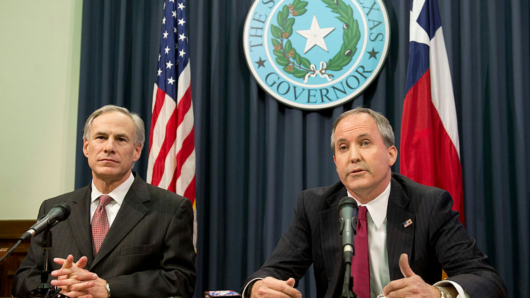 Texas Gov. Greg Abbott, l, and Attorney General Ken Paxton hold a press conference to address a Texas federal court's decision on the immigration lawsuit filed by 26 states challenging President Obama. Paxton was indicted Monday on three counts of securities fraud unrelated to his official duties.