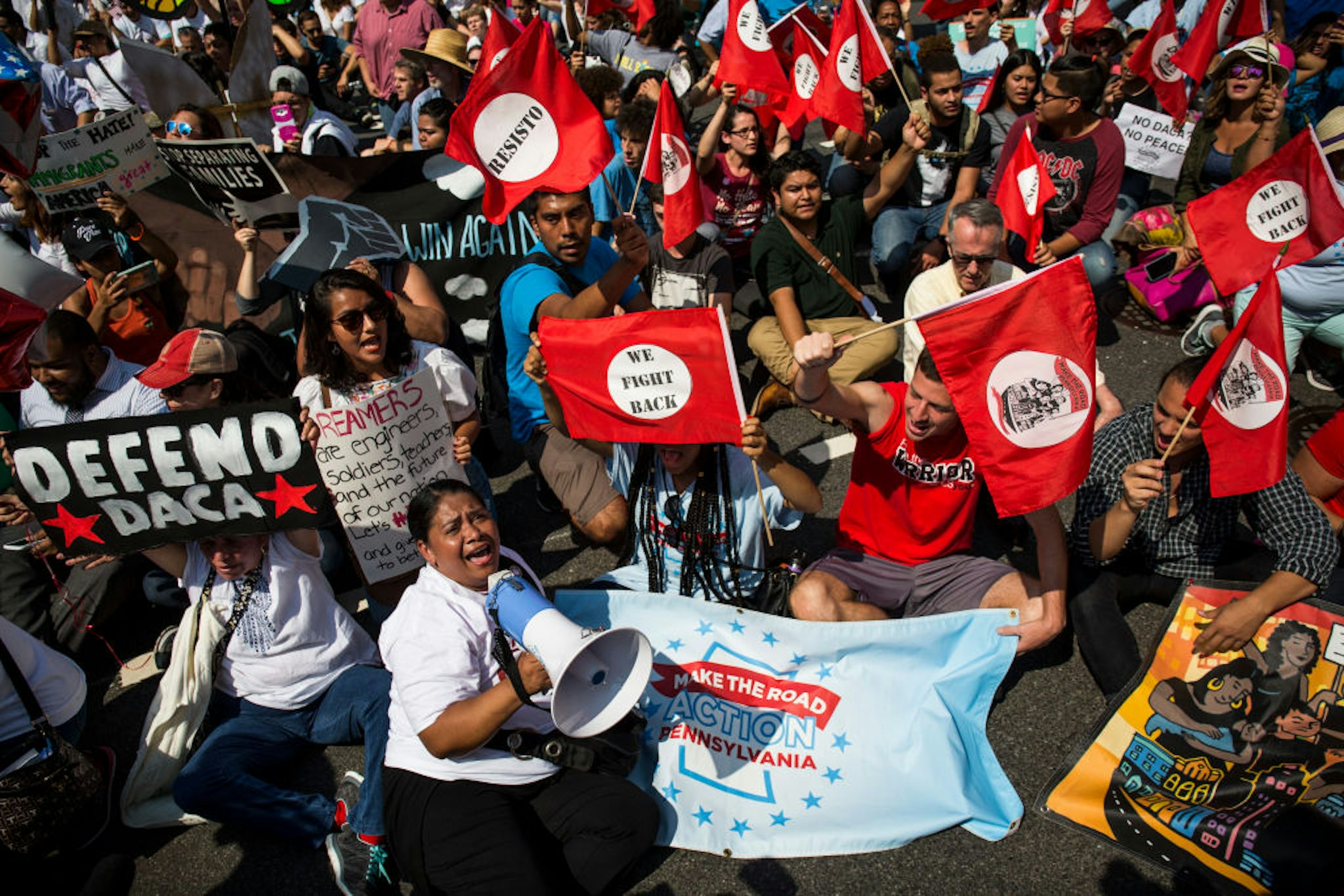 WASHINGTON, DC - SEPTEMBER 5: Demonstrators sit on Pennsylvania Avenue during a demonstration in response to the Trump Administration's announcement that it would end the Deferred Action for Childhood Arrivals (DACA) program on September 5, 2017 in Washington, DC. DACA, an immigration policy passed by former President Barack Obama, allows certain undocumented immigrants who arrived in the United States as minors to receive renewable two-year deferred action from deportation and eligibility fork a work permit.