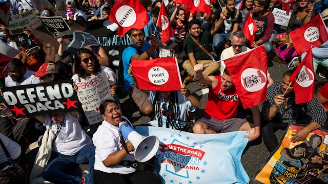 WASHINGTON, DC - SEPTEMBER 5: Demonstrators sit on Pennsylvania Avenue during a demonstration in response to the Trump Administration's announcement that it would end the Deferred Action for Childhood Arrivals (DACA) program on September 5, 2017 in Washington, DC. DACA, an immigration policy passed by former President Barack Obama, allows certain undocumented immigrants who arrived in the United States as minors to receive renewable two-year deferred action from deportation and eligibility fork a work permit.