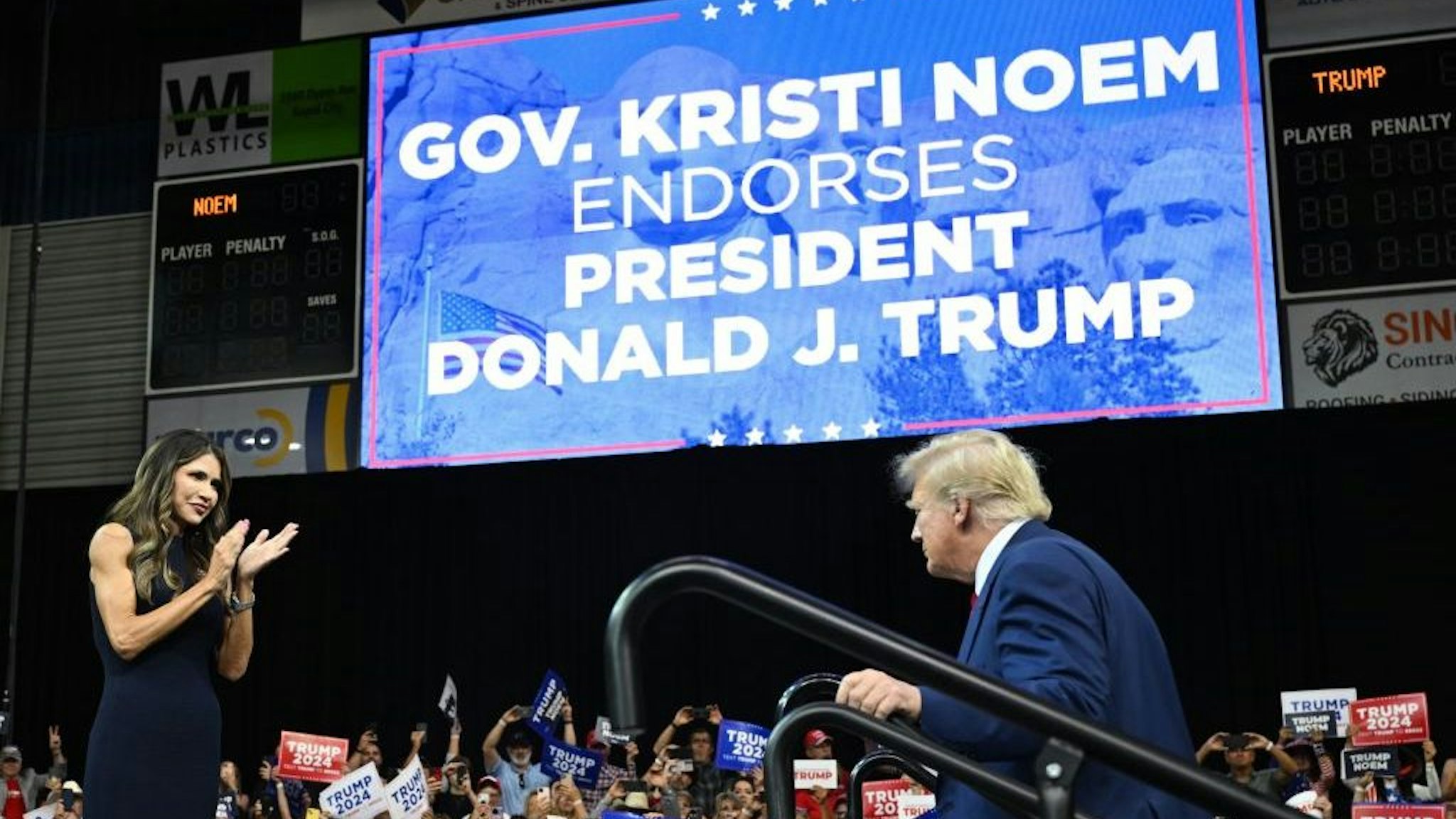 South Dakota Governor, Kristi Noem welcomes former US president and 2024 Republican Presidential hopeful Donald Trump to the stage during the South Dakota Republican Party's Monumental Leaders rally at the Ice Arena at the Monument in Rapid City, South Dakota, September 8, 2023. (Photo by ANDREW CABALLERO-REYNOLDS / AFP) (Photo by ANDREW CABALLERO-REYNOLDS/AFP via Getty Images)