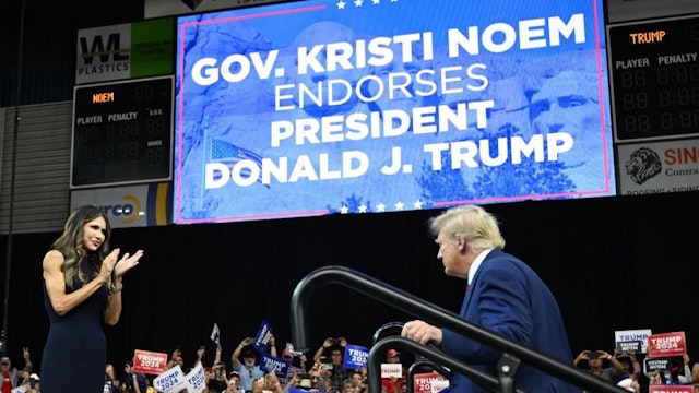 South Dakota Governor, Kristi Noem welcomes former US president and 2024 Republican Presidential hopeful Donald Trump to the stage during the South Dakota Republican Party's Monumental Leaders rally at the Ice Arena at the Monument in Rapid City, South Dakota, September 8, 2023. (Photo by ANDREW CABALLERO-REYNOLDS / AFP) (Photo by ANDREW CABALLERO-REYNOLDS/AFP via Getty Images)