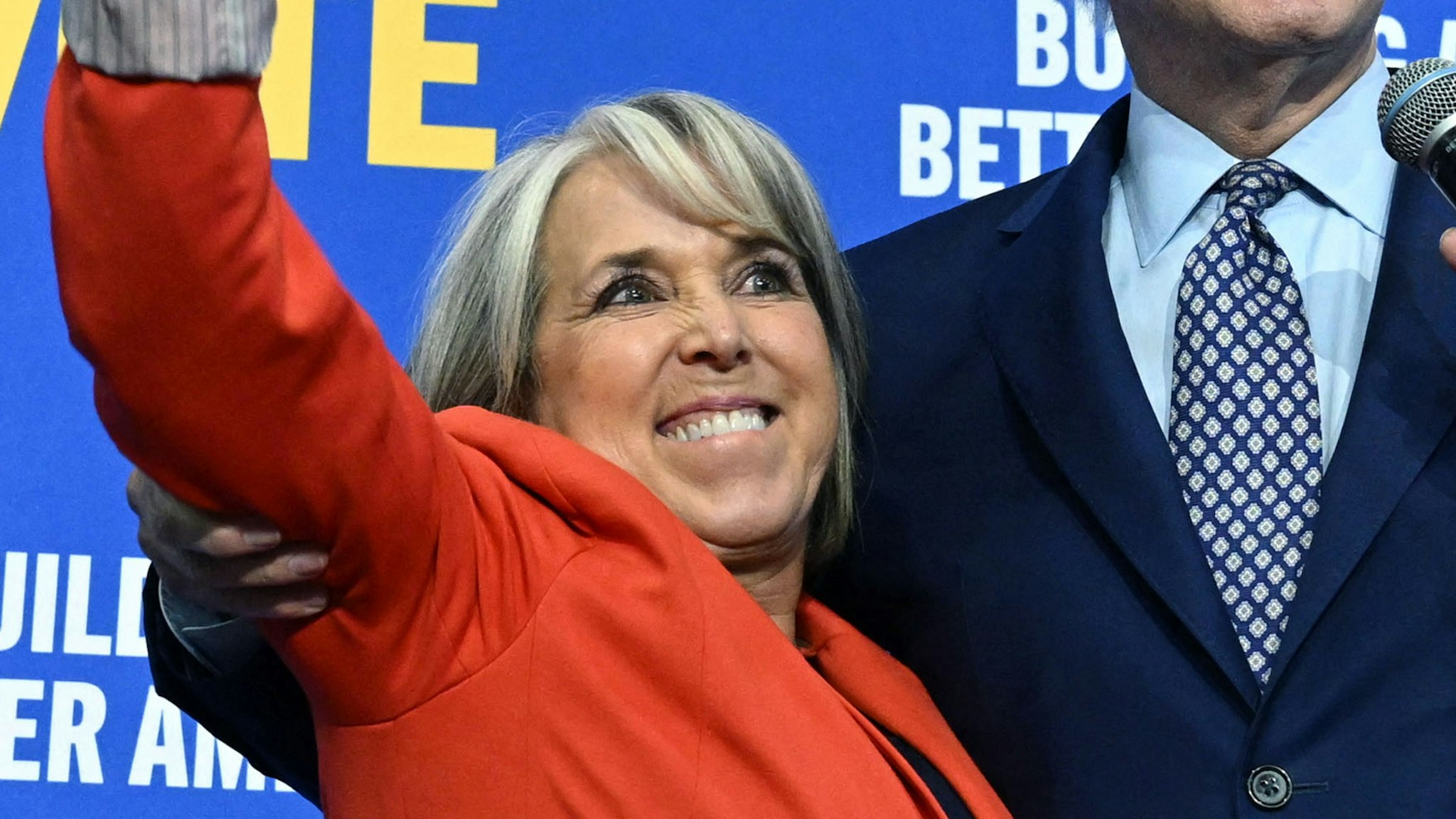 New Mexico Governor Michelle Lujan Grisham (L) gestures next to US President Joe Biden during a rally hosted by the Democratic Party of New Mexico at Ted M. Gallegos Community Center in Albuquerque, New Mexico, on November 3, 2022.