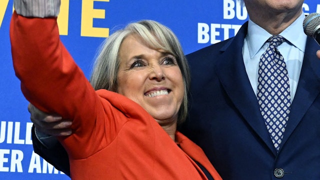 New Mexico Governor Michelle Lujan Grisham (L) gestures next to US President Joe Biden during a rally hosted by the Democratic Party of New Mexico at Ted M. Gallegos Community Center in Albuquerque, New Mexico, on November 3, 2022.