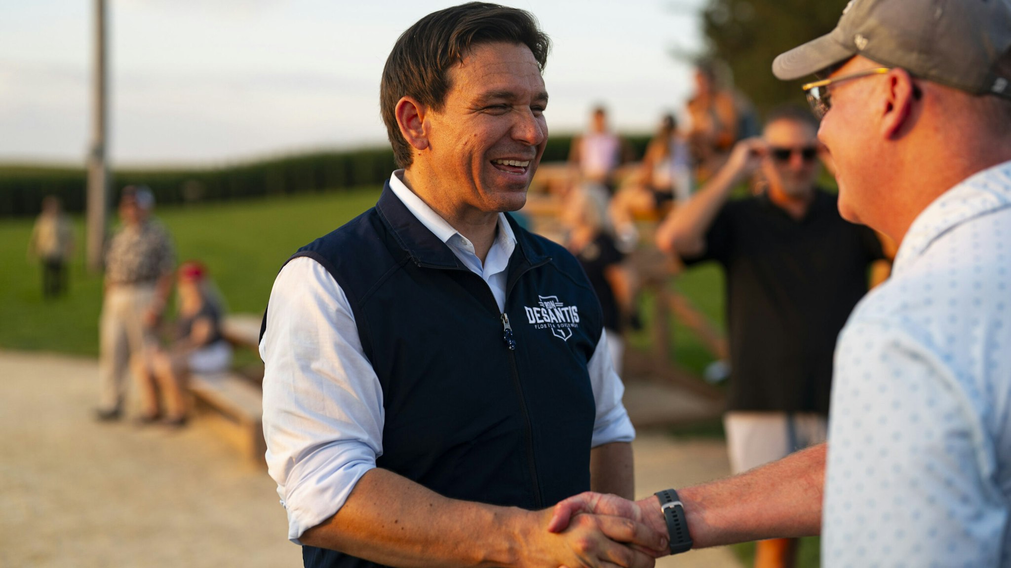 Ron DeSantis, governor of Florida and 2024 Republican presidential candidate, shakes hands with an attendee during a campaign stop at the Field of Dreams in Dyersville, Iowa, US, on Thursday, Aug. 24, 2023.