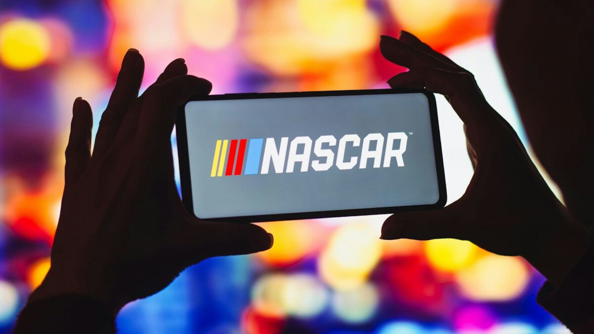 In this photo illustration, the National Association for Stock Car Auto Racing (NASCAR) logo is displayed on a smartphone screen.