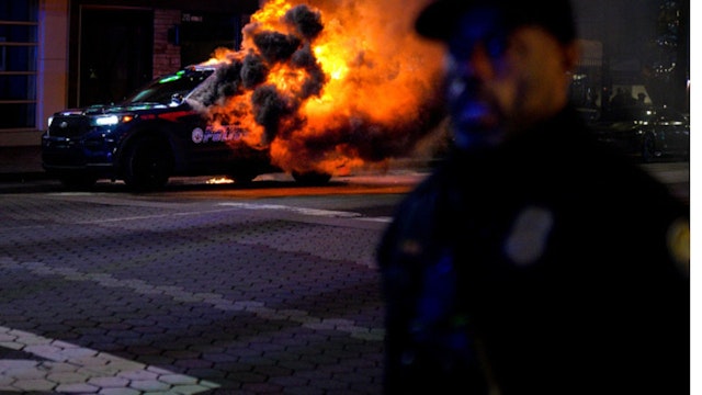 ATLANTA, USA - JANUARY 21: Firefighters work to extinguish a fire after an Atlanta police vehicle was set on fire during a "Stop cop city" protest in Atlanta, Georgia, United States on January 21, 2023. Multiple buildings were vandalized and an Atlanta police vehicle was set on fire as multiple arrests were made.