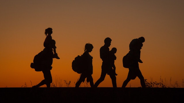 Migrants walk along a railway line after they have crossed the border from Serbia into Hungary close to the village of Roszke on August 29, 2015 near Szeged, Hungary.
