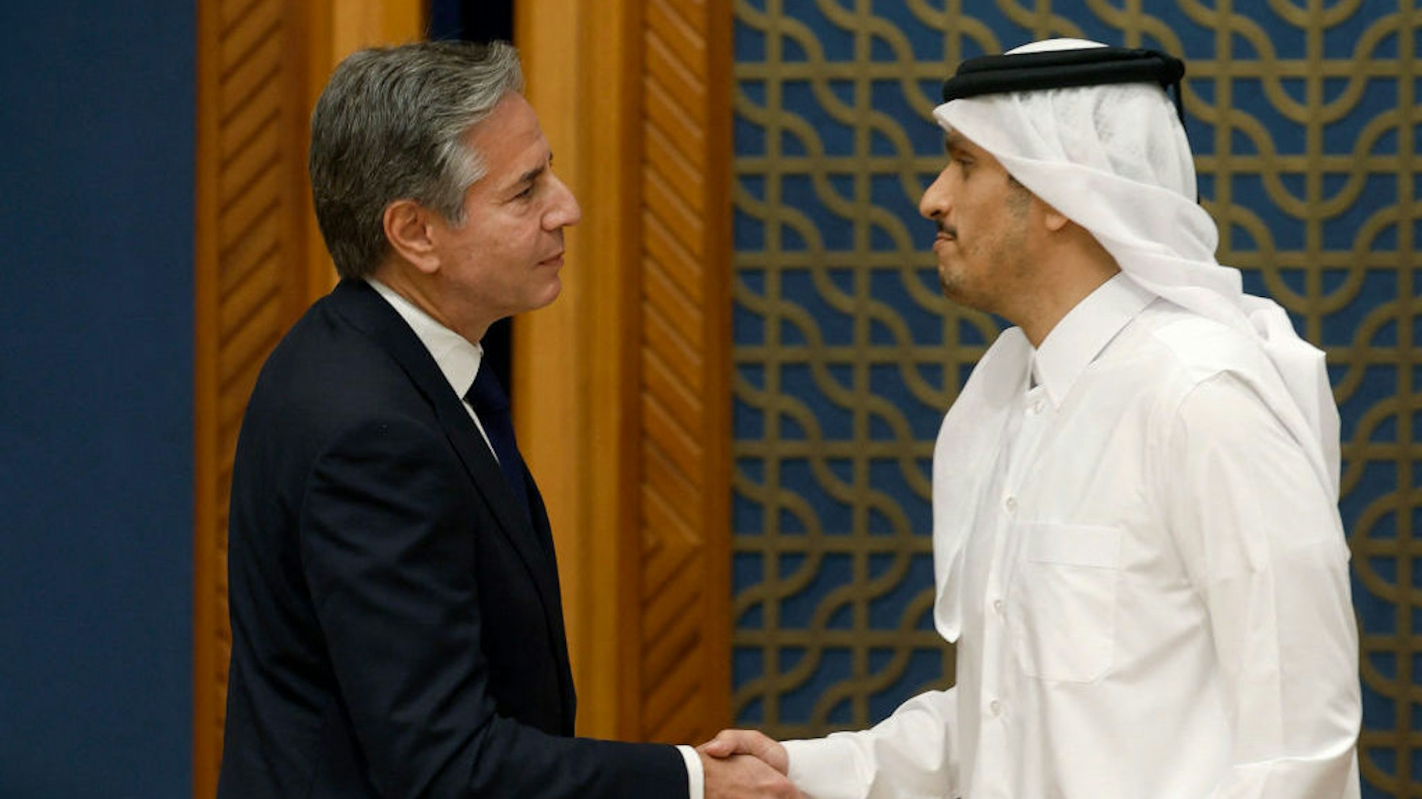 US Secretary of State Antony Blinken (L) shakes hands with Qatar's Prime Minister and Foreign Minister Mohammed bin Abdulrahman Al Thani following their meeting and press conference in Doha on October 13, 2023. US Secretary of State Antony Blinken on October 13, 2023, began a tour of six Arab capitals to build pressure on Hamas while Israel readies a massive offensive on the Gaza Strip following the militants' attacks. (Photo by KARIM JAAFAR / AFP) (Photo by KARIM JAAFAR/AFP via Getty Images)