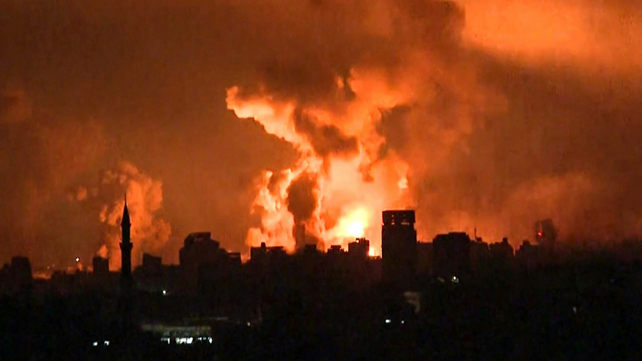 TOPSHOT - This image grab from an AFP TV footage shows balls of fire and smoke rising above Gaza City during an Israeli strike on October 27, 2023, as battles between Israel and the Palestinian Hamas movement continue. The Israeli army on the evening of October 27 carried out bombings of "unprecedented" intensity since the start of the war in the north of the Gaza Strip, particularly in Gaza City, according to images from AFP and the Hamas movement.