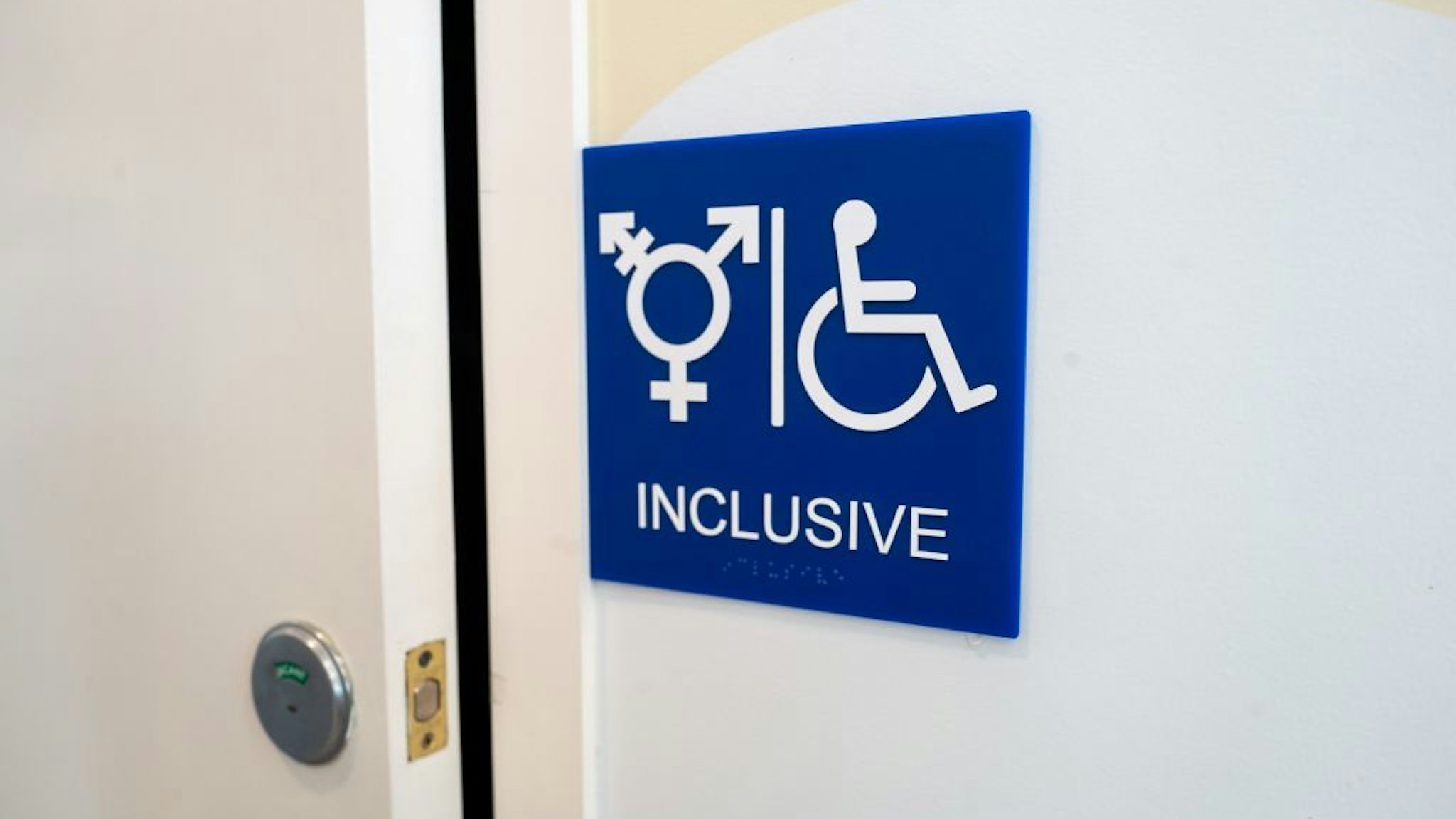 Sign for inclusive restroom, with symbol indicating male, female and transgender as well as handicapped symbol, part of LGBT rights initiatives in the Mission District neighborhood of San Francisco, California, July 18, 2019. (Photo by Smith Collection/Gado/Getty Images)