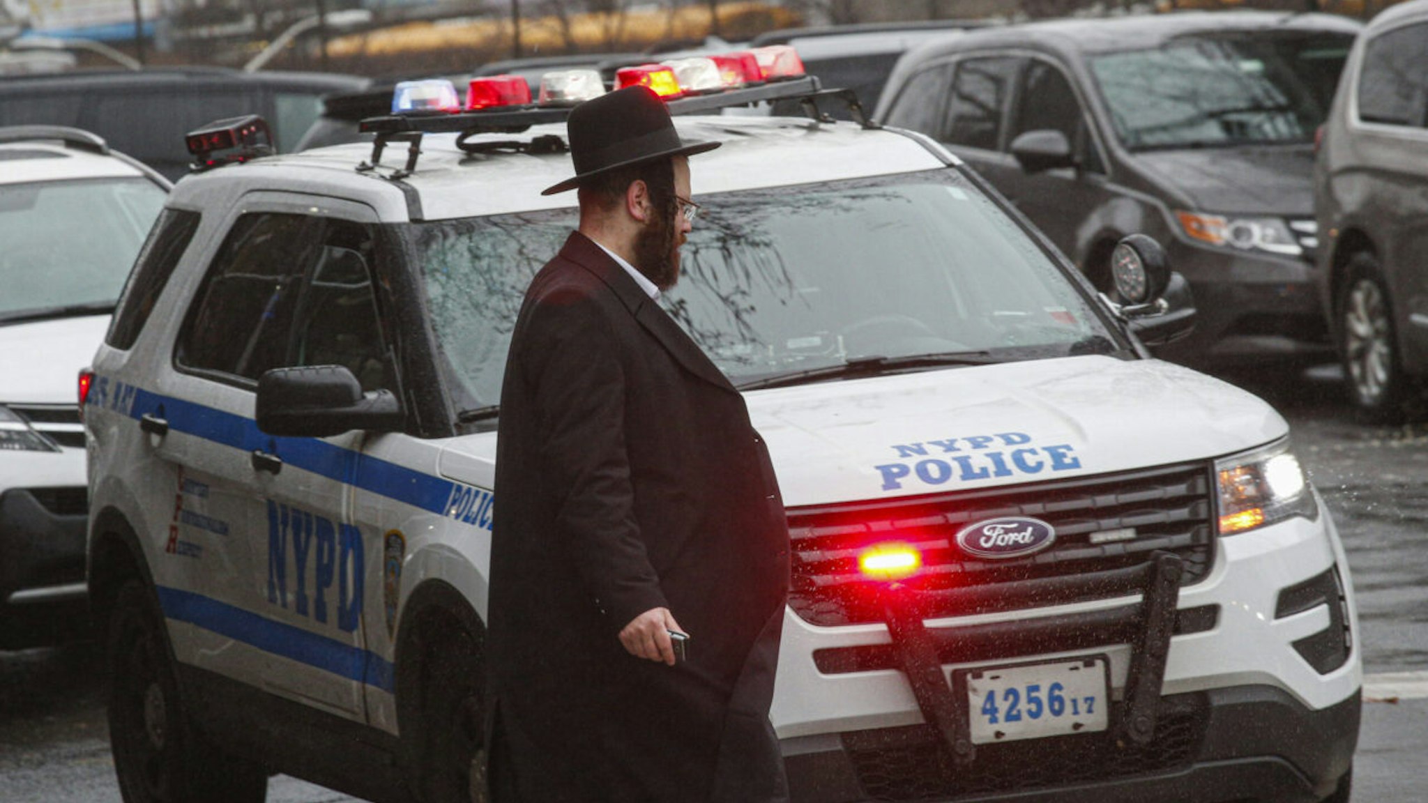 A NYPD car patrols in South Williamsburg Brooklyn on December 30, 2019 in New York City, two days after an intruder wounded five people at a rabbi's house in Monsey, New York during a gathering to celebrate the Jewish festival of Hanukkah.