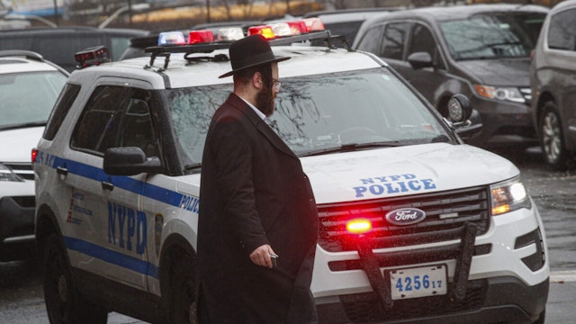 A NYPD car patrols in South Williamsburg Brooklyn on December 30, 2019 in New York City, two days after an intruder wounded five people at a rabbi's house in Monsey, New York during a gathering to celebrate the Jewish festival of Hanukkah.