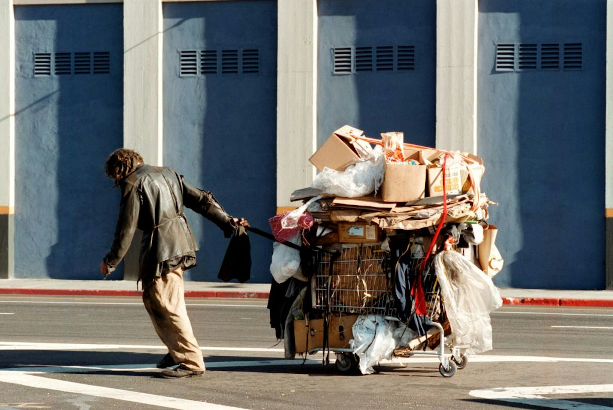 383367 23: A man tows his cart down the street on Skid Row December 11, 2000 in Los Angeles, CA. (Photo by David McNew/Newsmakers)