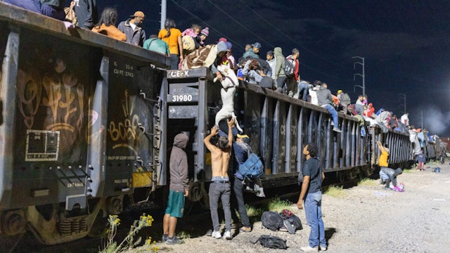 CHIHUAHUA - MEXCO - SEPTEMBER 29: Migrant people, mostly from Venezuela, are seen after the goods train they were travelling on stopped for over 12 hours, in the Chihuahuan desert in Chihuahuan, Mexico on September 29, 2023.