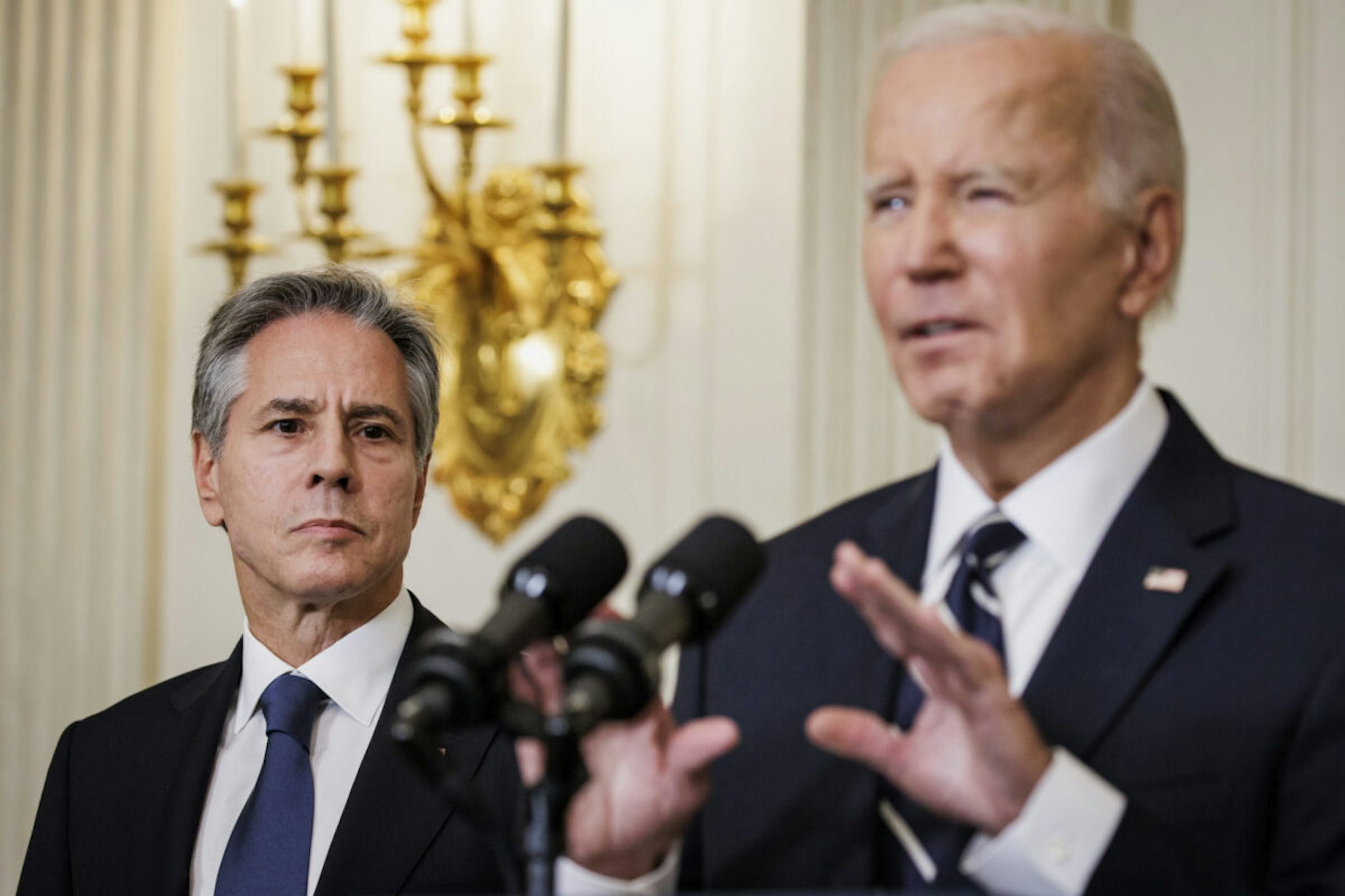 Secretary of State Antony Blinken stands alongside President Joe Biden as he delivers remarks on the terrorist attacks in Israel from the State Dining Room at the White House on October 7, 2023 in Washington, DC.