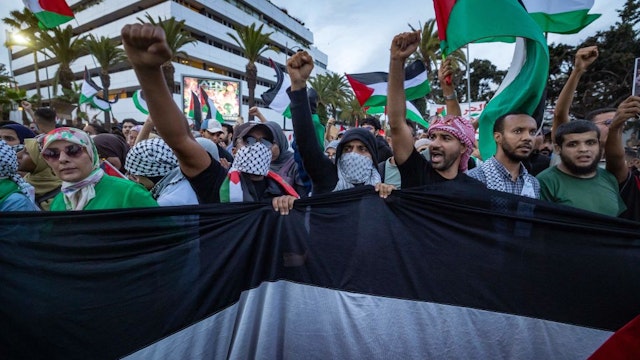 Demonstrators holding Palestinian flags gather near the US Consulate during a protest in support of Palestinians, in Casablanca, on October 18, 2023. (Photo by FADEL SENNA / AFP)