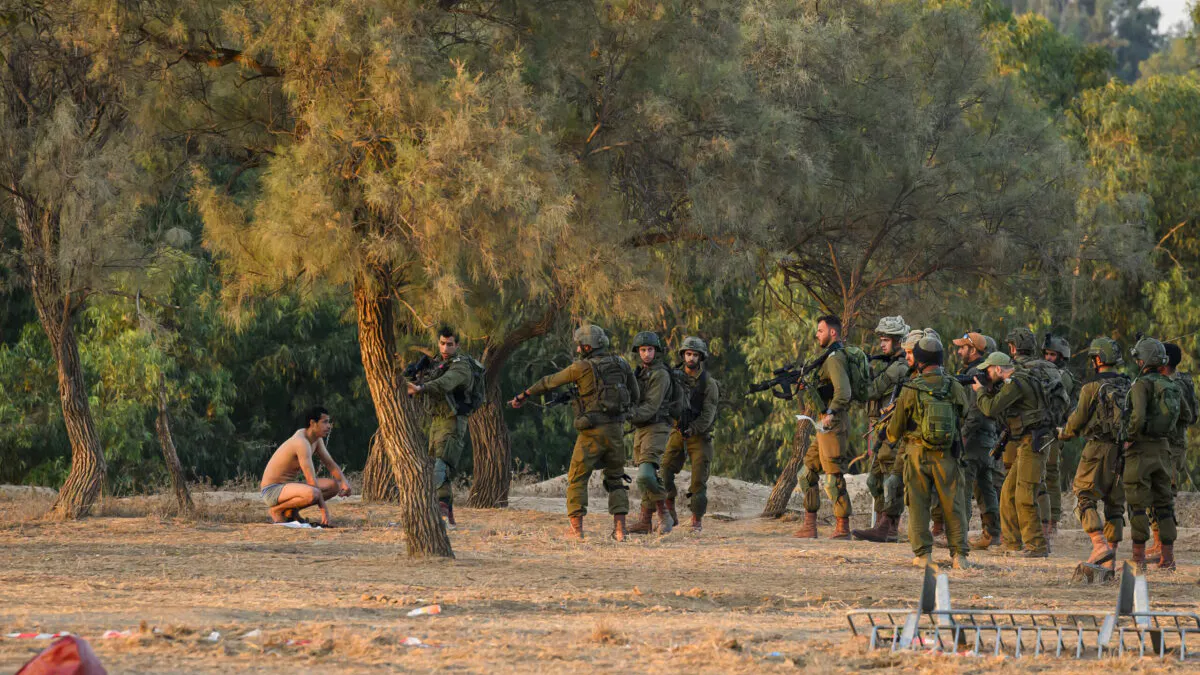 Reporter Witnesses Israeli Soldiers Capture Palestinian Militant At Site Of Music Festival Massacre