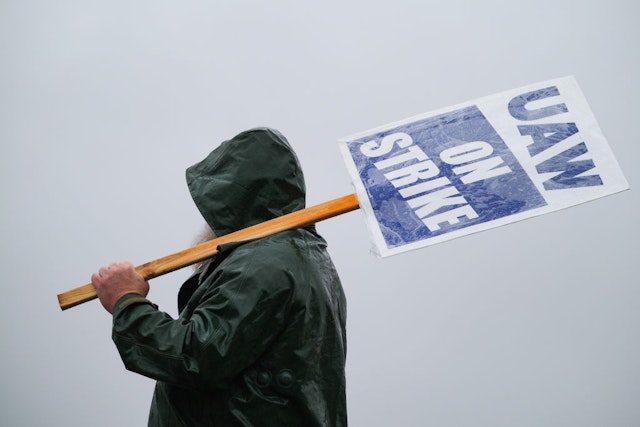 A "UAW On Strike" sign held on a picket line outside the General Motors Co. Spring Hill Manufacturing plant in Spring Hill, Tennessee, US, on Monday, Oct. 30, 2023. General Motors Co. reached a tentative agreement with the United Auto Workers, according to people familiar with the matter, bringing an end to a six-week-old strike that had upended US automobile production and cost the industry billions of dollars.